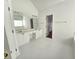 Bright bathroom featuring dual sinks, vanity, a large mirror, and a soaking tub at 3070 Ridge Oak Dr, Suwanee, GA 30024