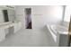 Bright bathroom featuring a soaking tub, and white cabinets and counters at 3070 Ridge Oak Dr, Suwanee, GA 30024