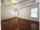 Large bedroom with hardwood floors, a ceiling fan, and multiple windows for natural light at 3070 Ridge Oak Dr, Suwanee, GA 30024