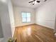 Cozy bedroom with hardwood floors, ceiling fan, and natural light from the window at 3070 Ridge Oak Dr, Suwanee, GA 30024