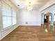 Dining room with hardwood floors, chandelier, wainscoting, and large windows at 3070 Ridge Oak Dr, Suwanee, GA 30024