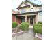 Inviting front entrance with brick accents, columns, manicured shrubs, and a paved walkway leading to the door at 3070 Ridge Oak Dr, Suwanee, GA 30024