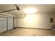 Attached garage featuring an automatic door, lighting, and ample space for parking and storage at 3070 Ridge Oak Dr, Suwanee, GA 30024