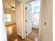 Bedroom hallway showing hardwood flooring, access to bathroom, and natural light at 3070 Ridge Oak Dr, Suwanee, GA 30024