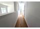 Long hallway with hardwood floors and an archway leading to an adjacent room at 3070 Ridge Oak Dr, Suwanee, GA 30024