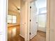 Bedroom hallway showing hardwood flooring, access to bathroom, and natural light at 3070 Ridge Oak Dr, Suwanee, GA 30024