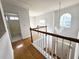 Bright hallway featuring hardwood floors, white trim, and a stylish chandelier at 3070 Ridge Oak Dr, Suwanee, GA 30024
