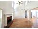 Spacious living room featuring a brick fireplace, hardwood floors, and abundant natural light from large windows at 3070 Ridge Oak Dr, Suwanee, GA 30024