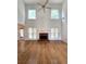 Spacious living room with high ceilings, a brick fireplace, large windows, and hardwood flooring at 3070 Ridge Oak Dr, Suwanee, GA 30024