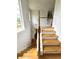 Elegant wooden staircase with white railing, leading to the upper level of the home with natural light at 3070 Ridge Oak Dr, Suwanee, GA 30024