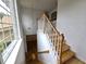 Elegant staircase with wooden banister, white risers, and a large window for natural light at 3070 Ridge Oak Dr, Suwanee, GA 30024