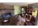 Living room featuring a brick fireplace, hardwood floors, and a vintage cabinet at 3291 Peachtree St, Lithia Springs, GA 30122