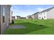Spacious backyard with lush green grass in a new home community at 169 Aster Avenue, Locust Grove, GA 30248
