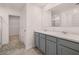 Double sink bathroom vanity with gray cabinets and a view into the walk-in closet at 169 Aster Avenue, Locust Grove, GA 30248