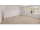 Large bedroom with window and neutral carpet at 169 Aster Avenue, Locust Grove, GA 30248