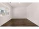 Bright bedroom featuring dark hardwood floors and a large window at 169 Aster Avenue, Locust Grove, GA 30248