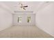 Spacious bedroom with a tray ceiling, ceiling fan, and two windows providing natural light at 169 Aster Avenue, Locust Grove, GA 30248