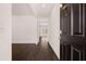 Spacious entryway featuring dark hardwood floors, white walls, and a view into adjacent living areas at 169 Aster Avenue, Locust Grove, GA 30248