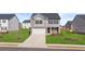 Charming two-story home with a well-manicured lawn and a two-car garage at 169 Aster Avenue, Locust Grove, GA 30248