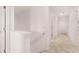 Bright hallway with neutral carpet and white walls leading to various rooms at 169 Aster Avenue, Locust Grove, GA 30248
