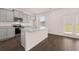 Modern kitchen with stainless steel appliances, gray cabinets, granite countertops, and an island at 169 Aster Avenue, Locust Grove, GA 30248