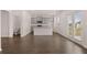 Open-concept kitchen featuring an island and gray cabinets, seamlessly connecting to the dining area at 169 Aster Avenue, Locust Grove, GA 30248