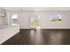 Open-concept living room with hardwood flooring and lots of natural light at 169 Aster Avenue, Locust Grove, GA 30248