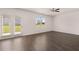 Well-lit living room with hardwood flooring and double doors to the backyard at 169 Aster Avenue, Locust Grove, GA 30248