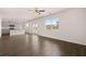 Open-concept living room featuring hardwood floors and a connected kitchen at 169 Aster Avenue, Locust Grove, GA 30248