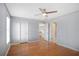 This bedroom features wood floors, neutral paint, and two entry doors at 5085 Hampton Bluff Ct, Roswell, GA 30075