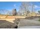 A large backyard featuring dormant grass and trees at 104 Camilla Dr, Carrollton, GA 30116