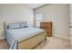 Bedroom featuring neutral carpet, a silver bed frame, and a wood dresser with a bright window at 104 Camilla Dr, Carrollton, GA 30116