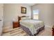 Neutral bedroom featuring natural light and a comfortable queen-sized bed with matching nightstand at 104 Camilla Dr, Carrollton, GA 30116
