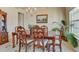 Formal dining room with hardwood table, six chairs, and a decorative chandelier at 104 Camilla Dr, Carrollton, GA 30116