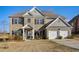 Charming two-story home with brick facade, attached two-car garage, and well-manicured lawn at 104 Camilla Dr, Carrollton, GA 30116
