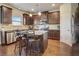 Modern kitchen with granite countertops, a stainless steel refrigerator, and wood floors at 104 Camilla Dr, Carrollton, GA 30116