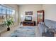 Cozy living room with a comfortable sofa, a decorative rug, and a large window at 104 Camilla Dr, Carrollton, GA 30116