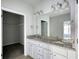Bright bathroom with granite countertop, double sinks and walk-in closet access at 690 Park Place Way, Social Circle, GA 30025