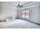 Spacious bedroom with a tray ceiling, large window and neutral carpet at 690 Park Place Way, Social Circle, GA 30025