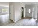 Entryway featuring neutral paint, wood-look floors, and access to powder room at 690 Park Place Way, Social Circle, GA 30025