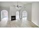 Open living room featuring fireplace, arches, and wood-look floors at 690 Park Place Way, Social Circle, GA 30025