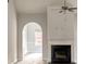 Open living room featuring fireplace, arches, and wood-look floors at 690 Park Place Way, Social Circle, GA 30025