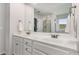 Bright bathroom featuring a dual vanity, mirrors, and access to shower at 224 Shoals Bridge Rd, Acworth, GA 30102