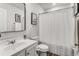 Bright bathroom featuring a modern vanity, framed mirror, and shower with a white textured curtain at 224 Shoals Bridge Rd, Acworth, GA 30102
