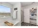 Bathroom featuring a soaking tub, large window, and open access to main bedroom at 224 Shoals Bridge Rd, Acworth, GA 30102