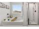 Bright bathroom featuring a soaking tub, shower, and white cabinets at 224 Shoals Bridge Rd, Acworth, GA 30102