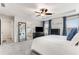 Bright bedroom featuring a large mirror, carpeted floors, a ceiling fan, and big windows at 224 Shoals Bridge Rd, Acworth, GA 30102