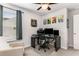 Bright bedroom featuring a ceiling fan, chair, desk, and a colorful wall art, creating a comfortable space at 224 Shoals Bridge Rd, Acworth, GA 30102