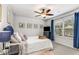 Cozy bedroom with plush bedding, a ceiling fan, and a large window at 224 Shoals Bridge Rd, Acworth, GA 30102