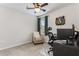 Bright bedroom featuring a ceiling fan, chair, desk, and a colorful wall art, creating a comfortable space at 224 Shoals Bridge Rd, Acworth, GA 30102